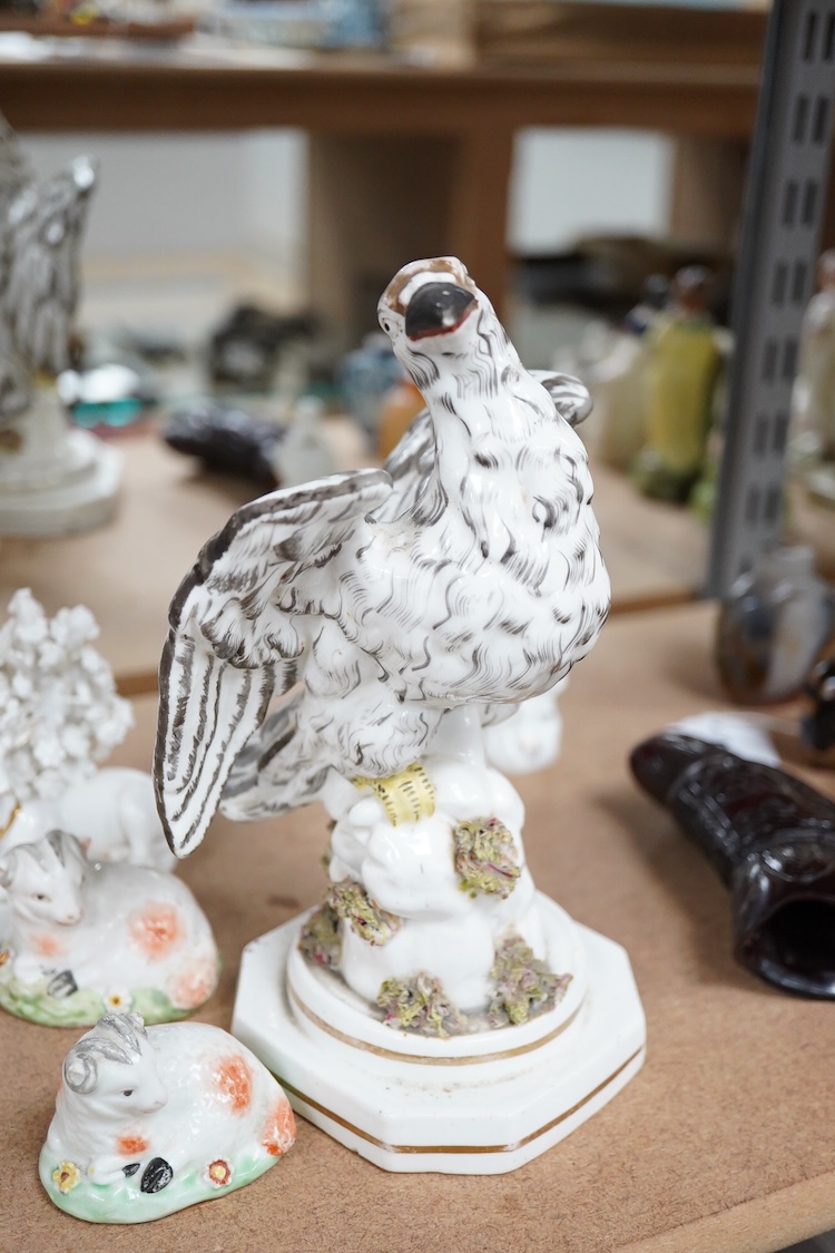 A rare Staffordshire porcelain model of an eagle or vulture, c.1830-50, and five Derby porcelain models, 1810–30; two recumbent sheep, a pug dog, a deer and a dove, 20cm high